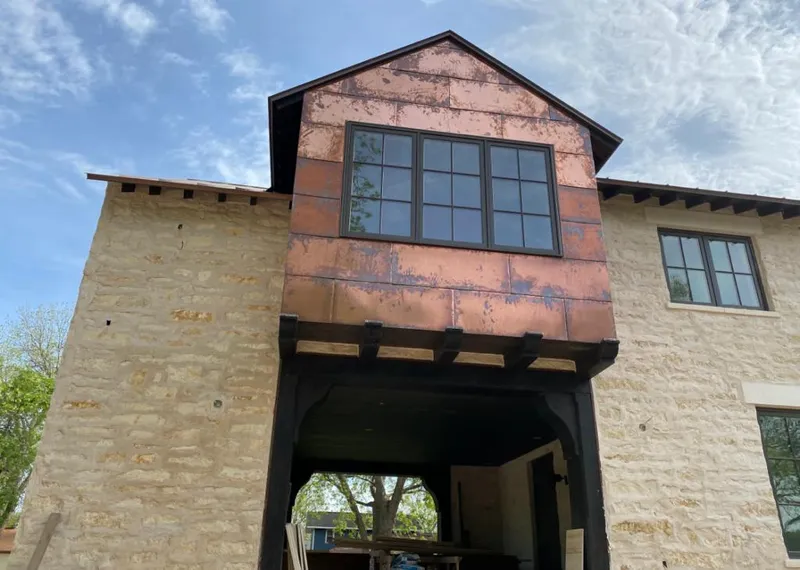 Copper metal panel facade on a stone building for Skylight Installation in Evanston